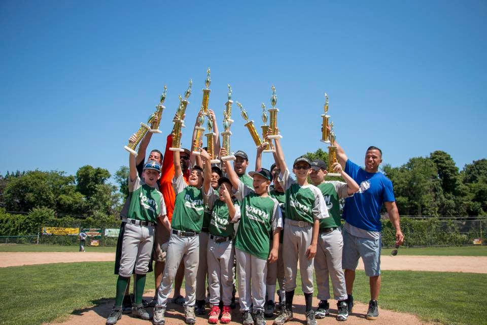 team celebrates with trophies