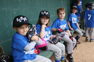 players in dugout smiling for the camera