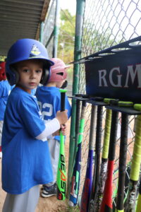 player in dugout with his bat