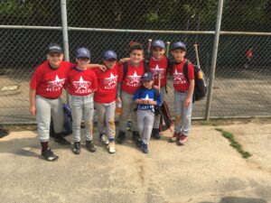 players in front of fence pose for picture