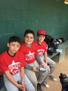 three players in dugout