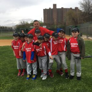 team and coach pose for picture on field