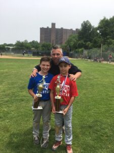 two playes and coach pose wiht trophies