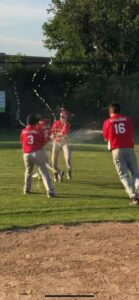 players and coach celebrate on the field